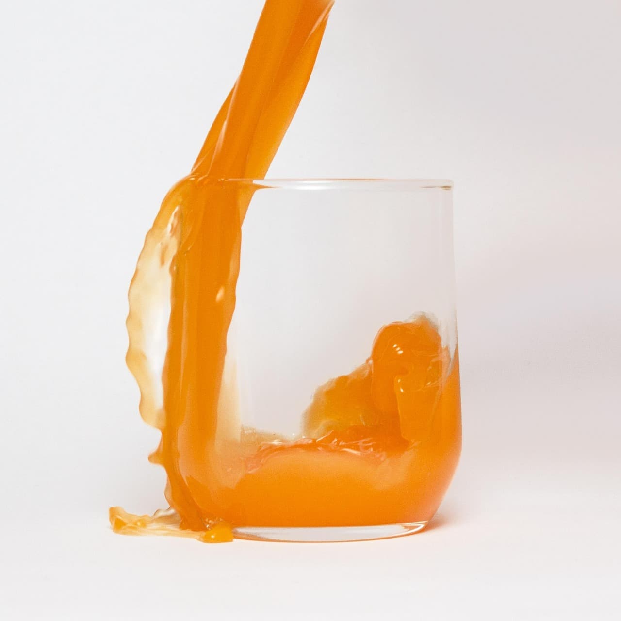 Orange juice being poured into a glass