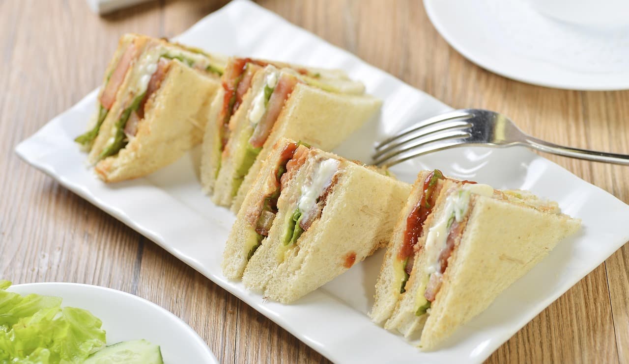 Sandwiches cut into triangles on a white plate